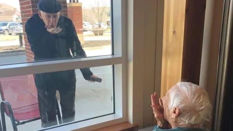 زوج عاشق پس از ۷۰ سال زندگی مشترک، تنها از پشت پنجره برای هم بوسه می‌فرستند